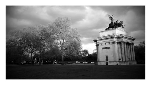 Statue of building against cloudy sky