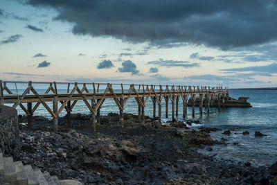 Pier over sea against sky