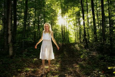 Young woman walking in forest