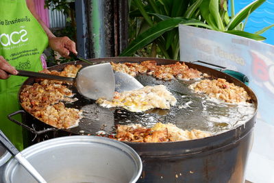 Hand holding food on table at market