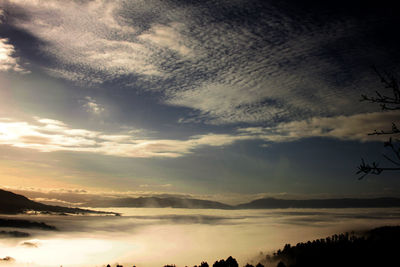 Scenic view of mountains against cloudy sky