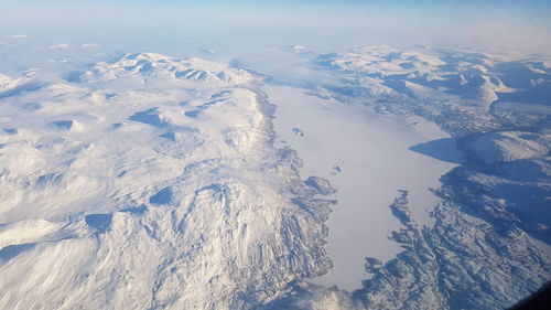 Aerial view of snowcapped mountains against sky