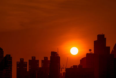 Business building in downtown at dusk with beautiful sunset sky. silhouette of condo and apartment