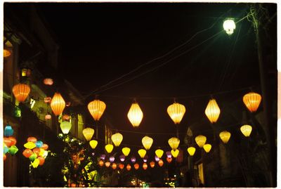 Low angle view of lamp post at night