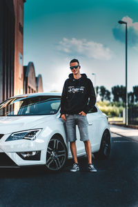 Portrait of man with sunglasses standing on street in city