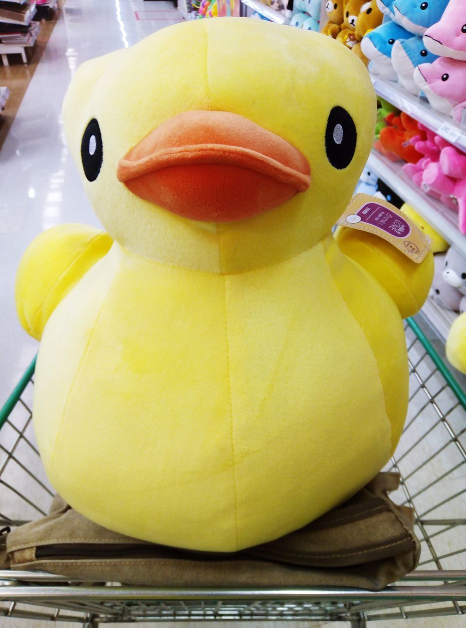 CLOSE-UP OF YELLOW TOYS IN AMUSEMENT PARK