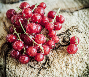 High angle view of red berries on wood