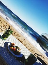 Panoramic shot of fruit on beach against clear sky