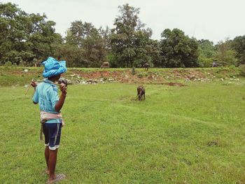 Rear view of man and woman on field