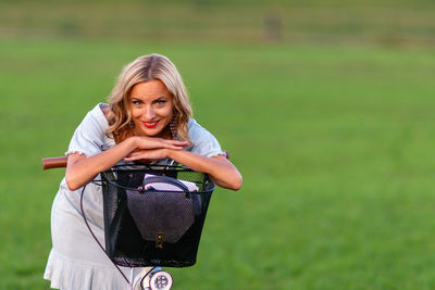 Portrait of woman standing on field