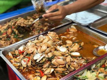 Cropped hand of man preparing food