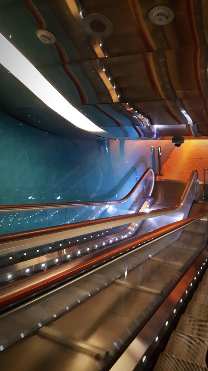 HIGH ANGLE VIEW OF ILLUMINATED ESCALATOR IN UNDERGROUND