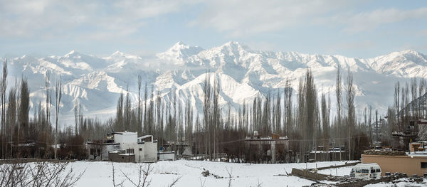 Scenic view of snow covered mountains against sky