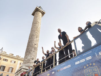 Low angle view of people walking on building