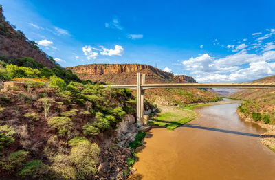 Bridge over river against sky