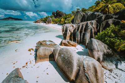 Scenic view of rocky beach against sky