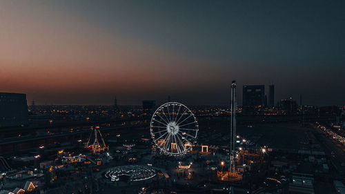 High angle view of illuminated cityscape against sky at night