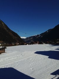 Scenic view of frozen mountains against sky