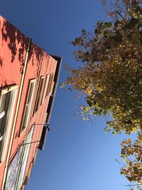 Low angle view of building against clear blue sky