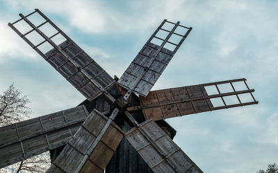 Low angle view of traditional windmill against sky