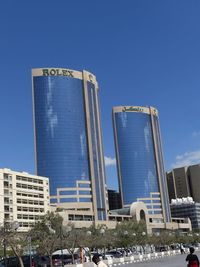 Low angle view of modern buildings against blue sky