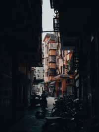 Street amidst buildings in city at night