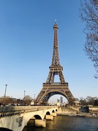 Bridge by eiffel tower against sky