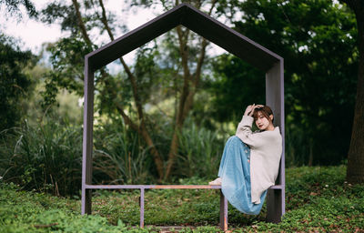 Portrait of young woman standing on field