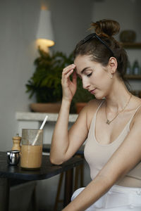 Young woman sitting on table