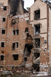 Cities of ukraine after the russian occupation. destroyed buildings on the streets of irpen. 