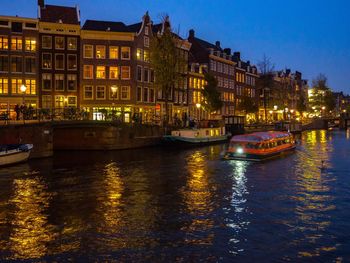 Canal passing through city at night