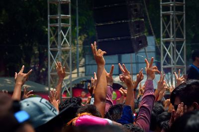 Arms raised in music concert