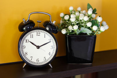 Close-up of clock on table