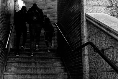 Rear view of people walking on stairs