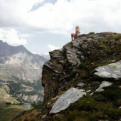 Scenic view of rocky mountains against cloudy sky