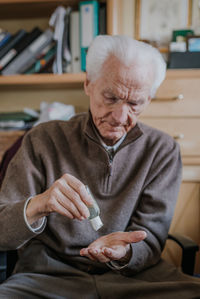 Midsection of man sitting on table