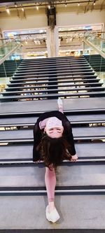 Full length of young woman on staircase