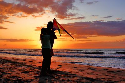 Man standing on beach during sunset