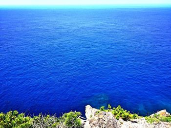 Scenic view of sea against blue sky