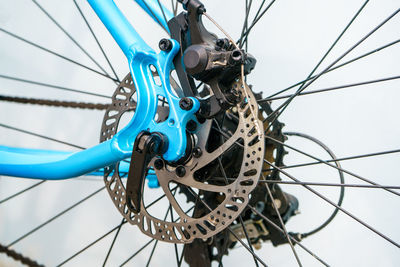 Low angle view of bicycle wheel against sky