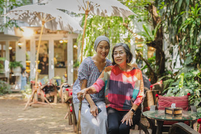 Portrait of beautiful asian senior mother and daughter smiling at the camera