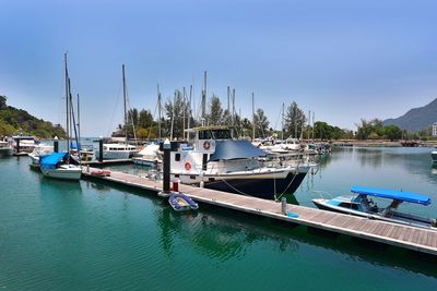 Boats moored at harbor