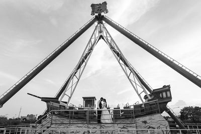 Low angle view of cranes against sky
