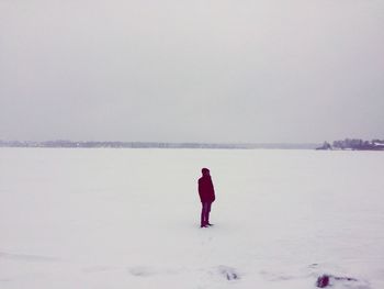 Rear view of man on snow covered land