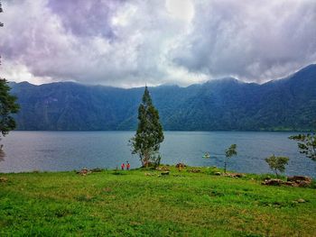 Scenic view of lake against cloudy sky