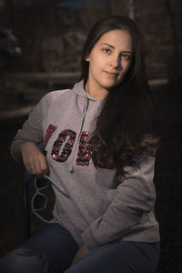 Portrait of young woman sitting outdoors