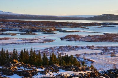 Scenic view of frozen lake against sky during winter