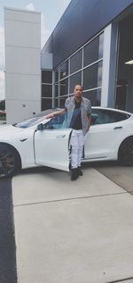 Full length of man standing by car