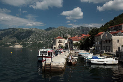 Boats in river with town in background