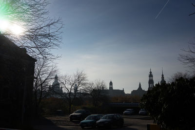 Cars on road against sky during sunset